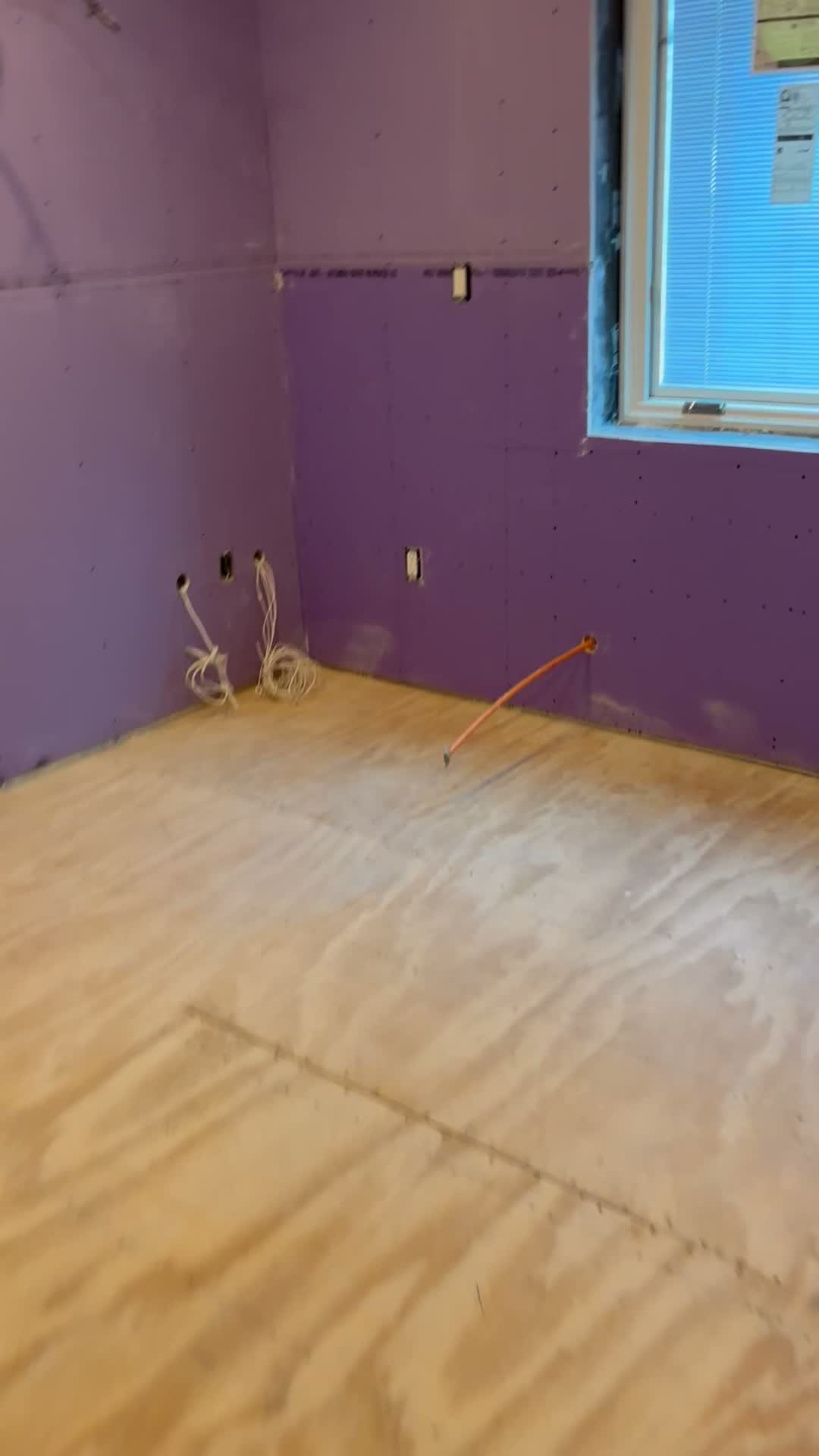 Bathroom with purple moisture resistant board installed before tile