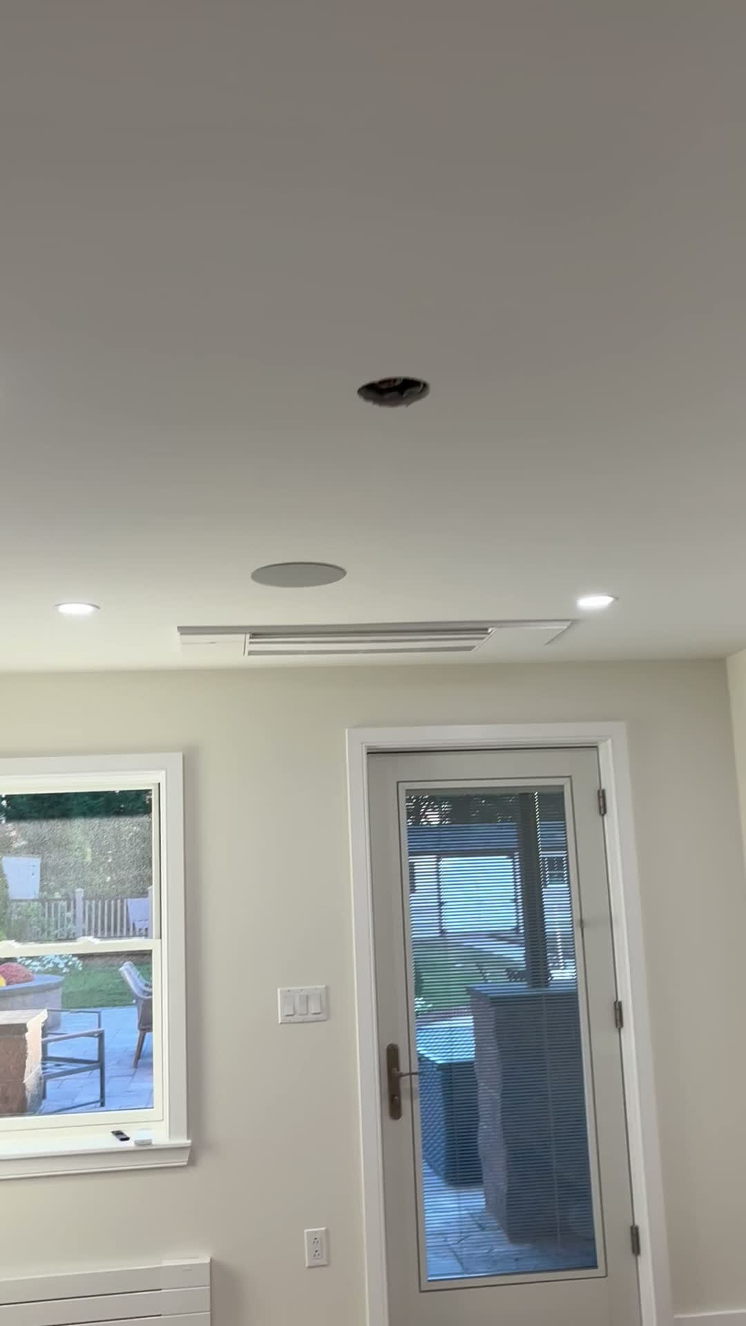 Finished living space with recessed lighting, ceiling speakers and a door out to the deck