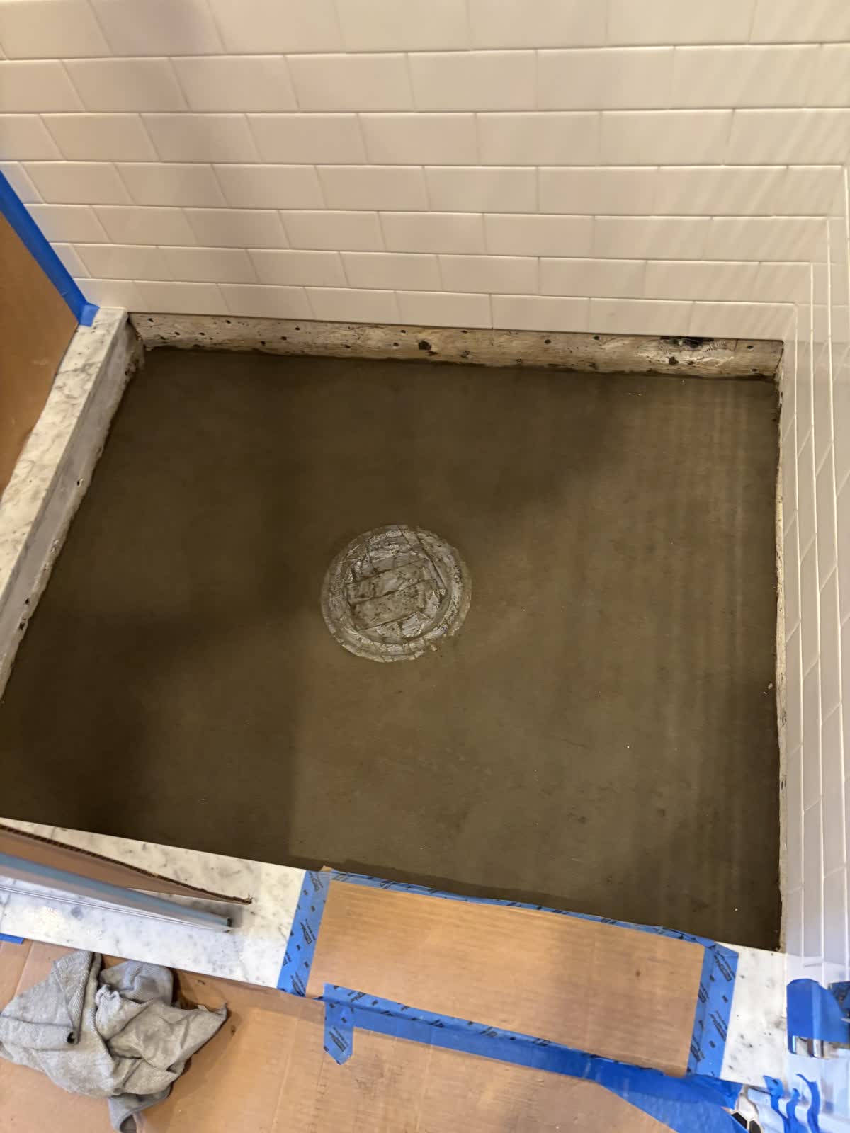 Fresh mortar bed floated into the shower pan around the drain